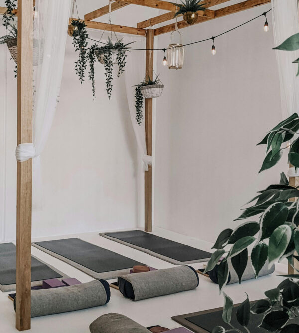 restorative yoga studio with yoga mats and pillows